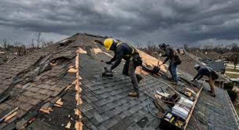 Technician documenting storm damage with a camera and notes